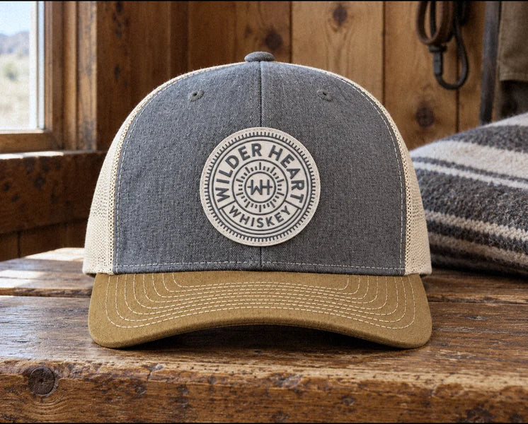 Close-up of the cream PVC patch with the raised Wilder Heart Whiskey medallion