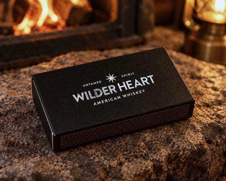 Close-up of the white Wilder Heart logo on a black matchbox