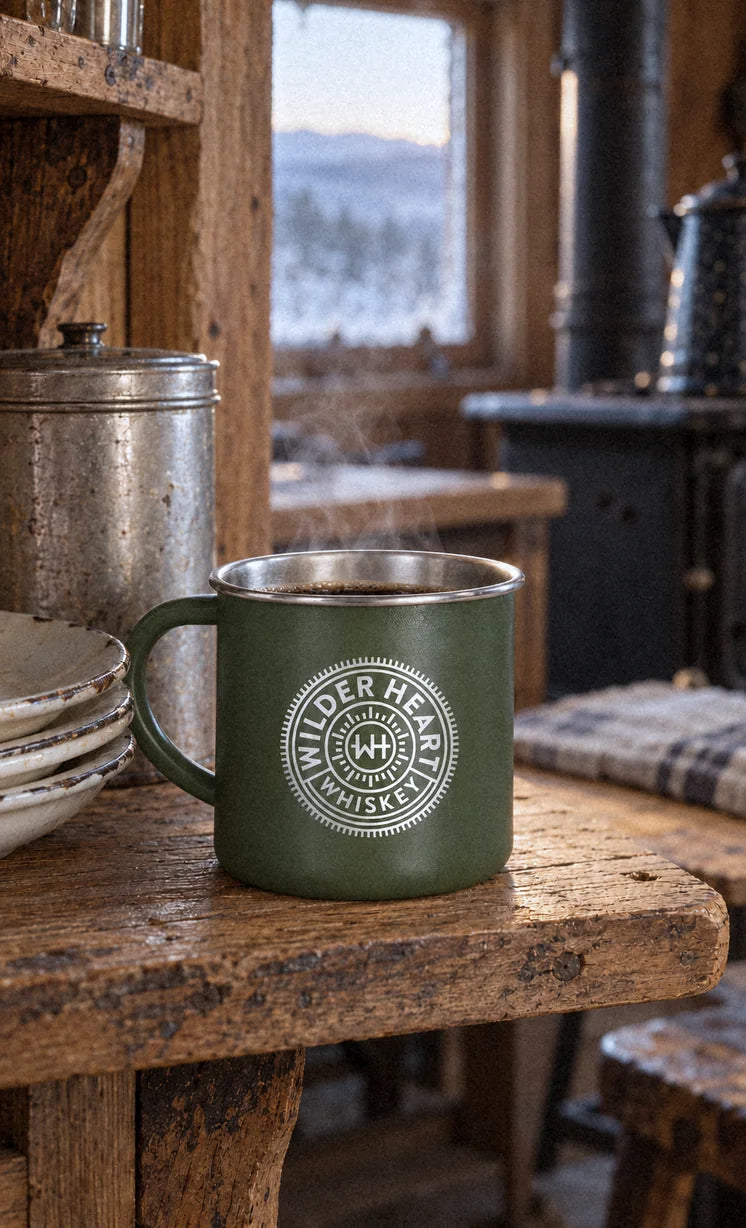 The green camp mug on a pine shelf by the cabin window