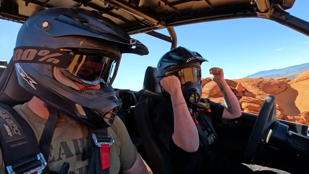 Nate and Chrissy celebrating in the dune buggy in the Utah sand dunes