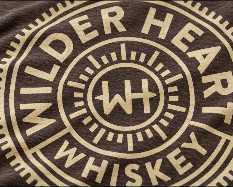 Close-up of the screen-printed medallion on the Espresso tee