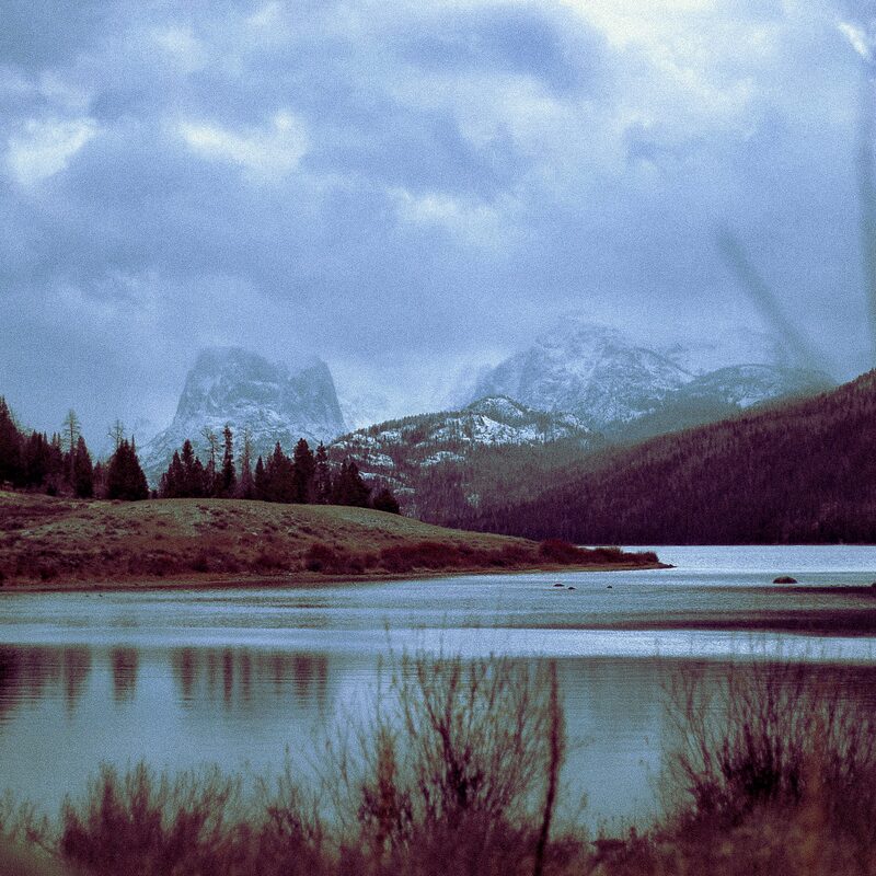A still lake below the mountains at dusk